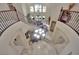 Grand foyer with a curved staircase, marble floors, and an elegant chandelier makes a dramatic entrance at 9046 Barium Rock Ave, Las Vegas, NV 89143