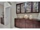 A hallway featuring built-in cabinetry with decorative items, and a doorway to another room at 9046 Barium Rock Ave, Las Vegas, NV 89143