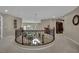Upstairs hallway with decorative railing overlooking the downstairs living area is bright and airy at 9046 Barium Rock Ave, Las Vegas, NV 89143