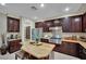 A full kitchen showcasing an island and granite countertops at 9046 Barium Rock Ave, Las Vegas, NV 89143