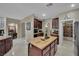 Spacious kitchen featuring granite countertops, dark wood cabinets, and modern stainless-steel appliances at 9046 Barium Rock Ave, Las Vegas, NV 89143