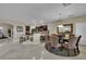 Open kitchen and dining area with a breakfast bar, dark wood cabinets, and an ornate mirror at 9046 Barium Rock Ave, Las Vegas, NV 89143