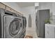 A laundry room featuring stainless steel washer and dryer at 9046 Barium Rock Ave, Las Vegas, NV 89143