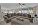 Spacious living room with recessed lights, a large sofa and many windows for natural light at 9046 Barium Rock Ave, Las Vegas, NV 89143