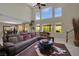 Inviting living room with tall windows, a plush sectional sofa, and stylish decor at 9046 Barium Rock Ave, Las Vegas, NV 89143