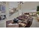 Open-concept living room with a staircase, fireplace, and dark wood accents at 9046 Barium Rock Ave, Las Vegas, NV 89143