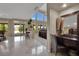 Bright living area with large windows, sliding glass doors, and a marble tile floor at 9046 Barium Rock Ave, Las Vegas, NV 89143