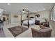 Large main bedroom with a four-poster bed, seating area, and lots of natural light is a luxurious retreat at 9046 Barium Rock Ave, Las Vegas, NV 89143