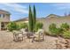 Charming outdoor patio featuring stone flooring, cozy seating, and a fire pit perfect for entertaining at 9046 Barium Rock Ave, Las Vegas, NV 89143