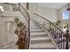 Grand staircase features rod iron railing, carpeted stairs, large windows and an open layout at 9046 Barium Rock Ave, Las Vegas, NV 89143