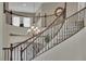 Beautiful staircase with wood railings and a decorative chandelier overhead at 9046 Barium Rock Ave, Las Vegas, NV 89143