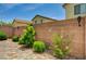 Inviting backyard with lush greenery and a well-maintained brick paver patio at 9137 Big Plantation Ave, Las Vegas, NV 89143