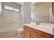 Bright bathroom with shower-tub combo, and a large vanity with updated fixtures at 9137 Big Plantation Ave, Las Vegas, NV 89143