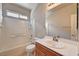 Bathroom featuring shower-tub combo, tile surround, and vanity with updated fixtures at 9137 Big Plantation Ave, Las Vegas, NV 89143