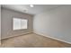 Neutral-toned bedroom with plush carpeting, window with blinds, and base-board trim at 9137 Big Plantation Ave, Las Vegas, NV 89143
