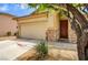 Charming home with a two-car garage, decorative stone accents, and desert landscaping at 9137 Big Plantation Ave, Las Vegas, NV 89143