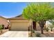 Charming single-story home featuring a two-car garage, desert landscaping, and stone accents at 9137 Big Plantation Ave, Las Vegas, NV 89143