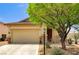 Charming single-story home featuring a two-car garage, desert landscaping, and stone accents at 9137 Big Plantation Ave, Las Vegas, NV 89143