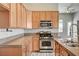 Charming kitchen featuring stainless steel appliances, granite countertops, and ample cabinet space at 9137 Big Plantation Ave, Las Vegas, NV 89143