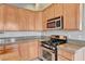 Well-equipped kitchen features granite countertops, stainless steel appliances, and ample cabinet space at 9137 Big Plantation Ave, Las Vegas, NV 89143