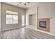 Living room with fireplace, modern ceiling fan, and glass patio door at 9137 Big Plantation Ave, Las Vegas, NV 89143