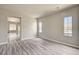 Bright living room with contemporary gray wood-look flooring and natural light at 9137 Big Plantation Ave, Las Vegas, NV 89143