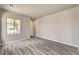 Bright living room with contemporary gray wood-look flooring and natural light at 9137 Big Plantation Ave, Las Vegas, NV 89143