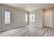 Bright living room with contemporary gray wood-look flooring and lots of natural light at 9137 Big Plantation Ave, Las Vegas, NV 89143