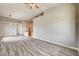 Large living area featuring plank flooring, open layout, and kitchen integration at 9137 Big Plantation Ave, Las Vegas, NV 89143