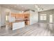 An open floor plan connects kitchen and living spaces with plentiful natural light and plank floors at 9137 Big Plantation Ave, Las Vegas, NV 89143
