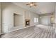 A large living space offers a fireplace, plank flooring, and seamless flow into other rooms at 9137 Big Plantation Ave, Las Vegas, NV 89143