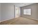 Spacious primary bedroom with plush carpeting and an en-suite bathroom with tile surround at 9137 Big Plantation Ave, Las Vegas, NV 89143