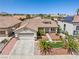 Aerial view of a single-story home with desert landscaping, tile roof, and a two-car garage at 9282 W Viking Rd, Las Vegas, NV 89147