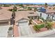 Aerial view of a single-story home with desert landscaping, tile roof, and a two-car garage at 9282 W Viking Rd, Las Vegas, NV 89147