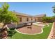 Private backyard features a patio, manicured desert landscaping, and artificial grass at 9282 W Viking Rd, Las Vegas, NV 89147