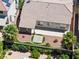 Aerial view of the landscaped backyard with patio, desert landscaping, and mature palm trees at 9282 W Viking Rd, Las Vegas, NV 89147