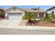 Charming single-Gathering home showcasing a manicured front yard and a two-car garage at 9282 W Viking Rd, Las Vegas, NV 89147