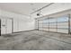 Spacious garage with ample storage cabinets, an automatic door, and concrete flooring at 9282 W Viking Rd, Las Vegas, NV 89147