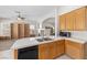 Kitchen view with white countertops and wooden cabinetry overlooking the living room at 9282 W Viking Rd, Las Vegas, NV 89147
