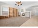 Bright living room features built-in bookshelves, a fireplace, and neutral carpeting at 9282 W Viking Rd, Las Vegas, NV 89147