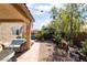 Backyard featuring a covered patio, landscaping, string lights, and privacy fencing at 9513 Perennial View Ave, Las Vegas, NV 89148