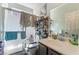 Bright bathroom featuring a glass shower, vanity with sink and mirror, and shelving for storage at 9513 Perennial View Ave, Las Vegas, NV 89148