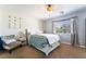 Comfortable bedroom with ceiling fan, Queen bed, carpeted floors, and lots of natural light at 9513 Perennial View Ave, Las Vegas, NV 89148