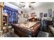 Cozy bedroom featuring unique bedframe, ceiling fan, and natural light from the window at 9513 Perennial View Ave, Las Vegas, NV 89148