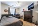 Comfortable bedroom featuring a dark wood dresser, and ceiling fan at 9513 Perennial View Ave, Las Vegas, NV 89148