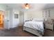 Carpeted bedroom with ceiling fan, Queen bed, ensuite bathroom, closet, and neutral walls at 9513 Perennial View Ave, Las Vegas, NV 89148