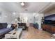Spacious living room featuring tile floors, neutral walls, staircase, comfortable sofas, and a TV area at 9513 Perennial View Ave, Las Vegas, NV 89148