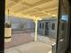 Covered patio and backyard with stone landscaping, including a shed with windows at , Henderson, NV 89014