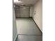 Attached two-car garage featuring concrete flooring, white walls, and an overhead door at , Henderson, NV 89014