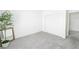 Minimalist bedroom with a mirror, plant, sliding-door closet, and neutral carpet at 10301 Coal Creek Pl, Las Vegas, NV 89134